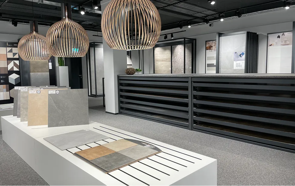 Etges & Dächert showroom with pendant lights and displays of stone and tile samples.